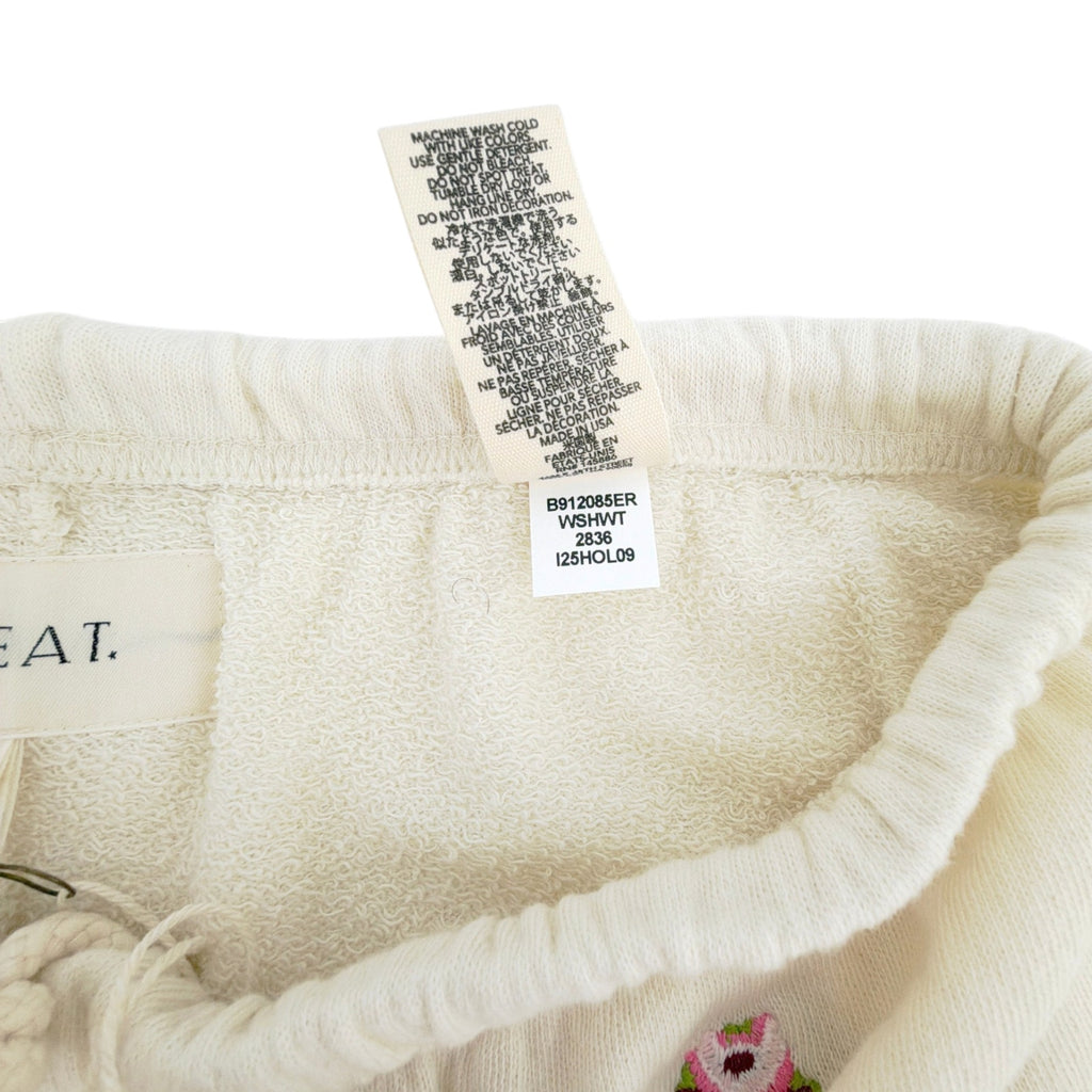 THE GREAT. The Stadium Sweatpant. Washed White with Embroidered Roses 1|S The Great.